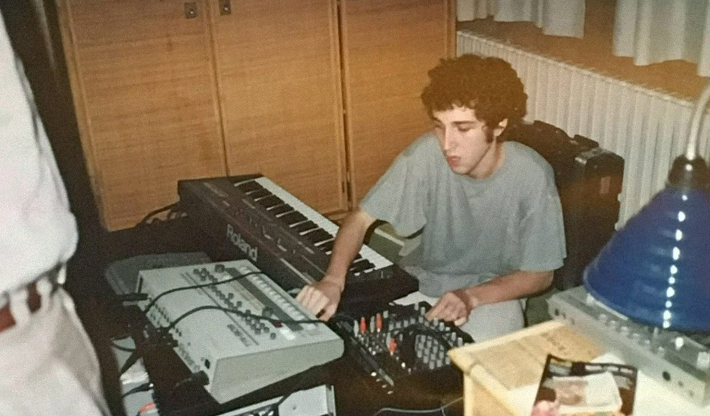 A photo of Thomas Bangalter playing a Roland Juno-106 and Roland TR-909.