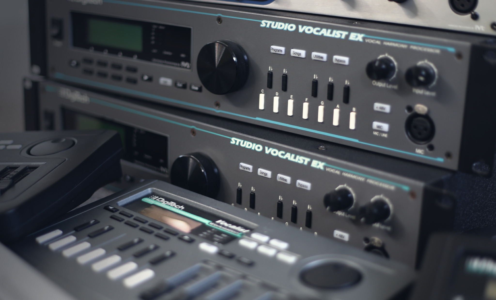 A photo of several harmonizers, including two DigiTech Studio Vocalist EX modesl.